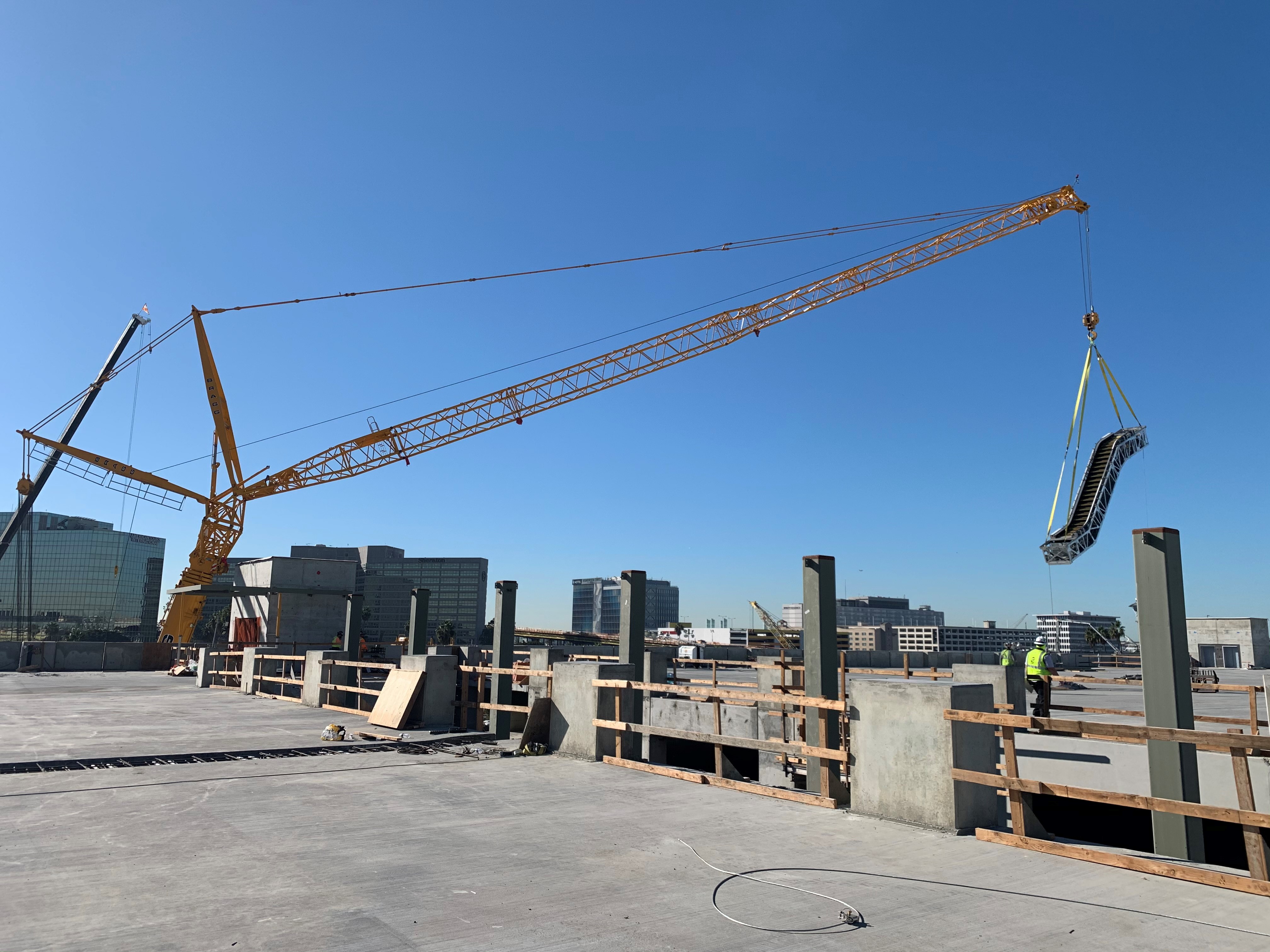 A crane lifting an escalator into place at the Intermodal Transportation Facility-West.