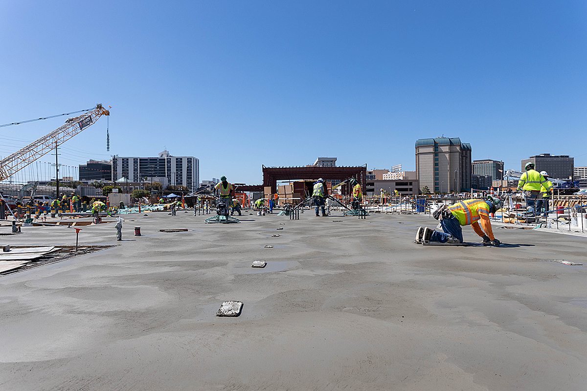 Concrete workers finish a slab at the Maintenance and Storage Facility.