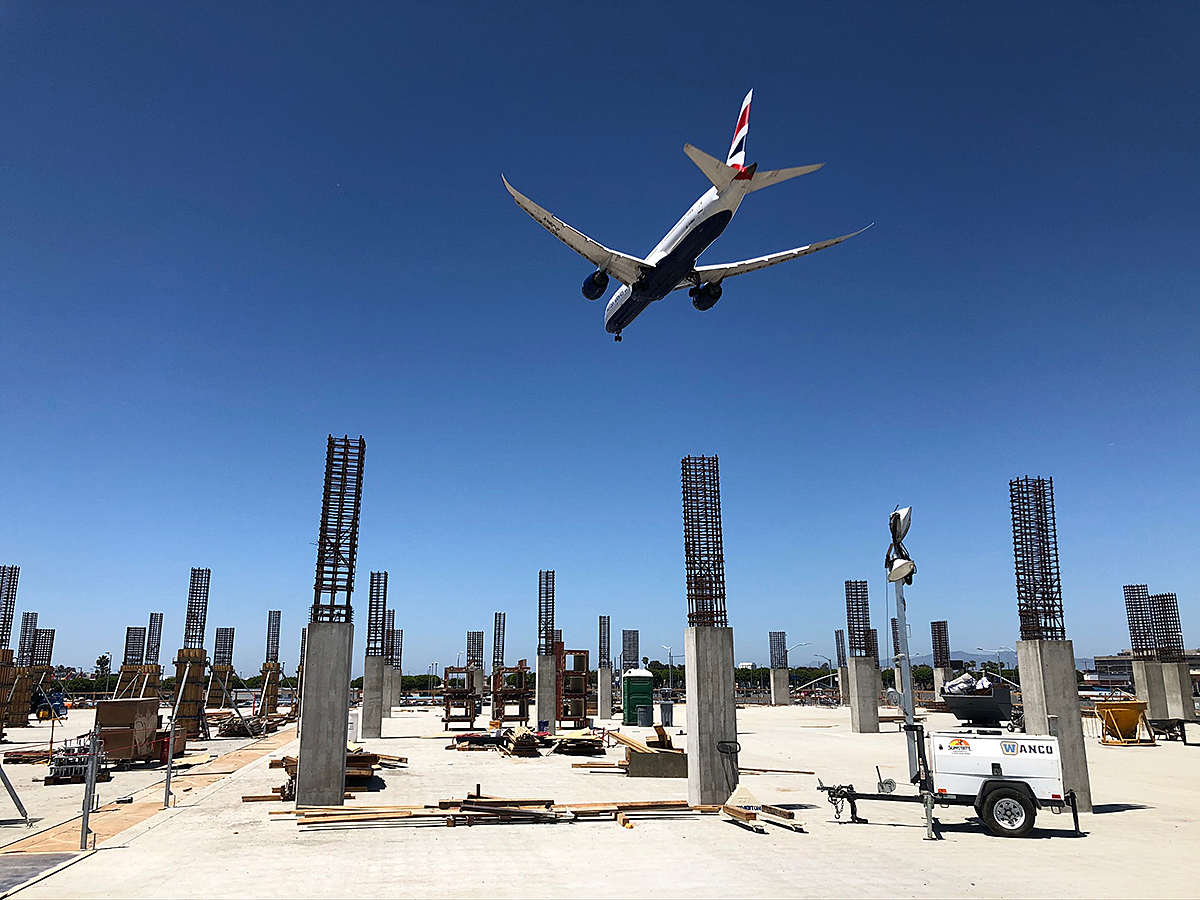 A British Airways plane flies over the second level of the LAX Economy Parking facility (formerly Intermodal Transportation Facility - West).