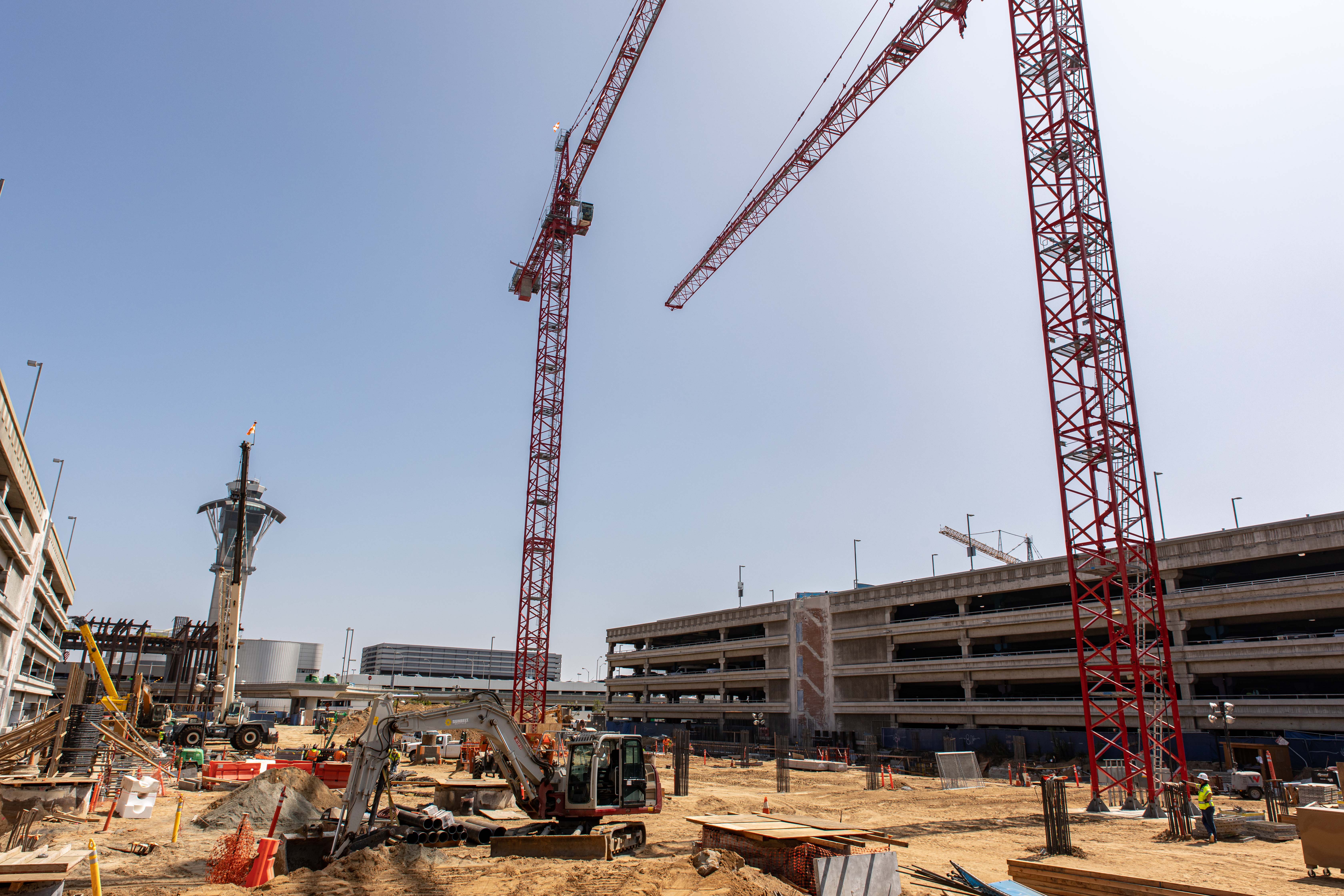 At the future West CTA station, the largest of the APM stations, tower cranes have been installed to facilitate new stages of construction.